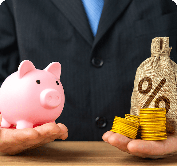 Piggy bank and coins in hand