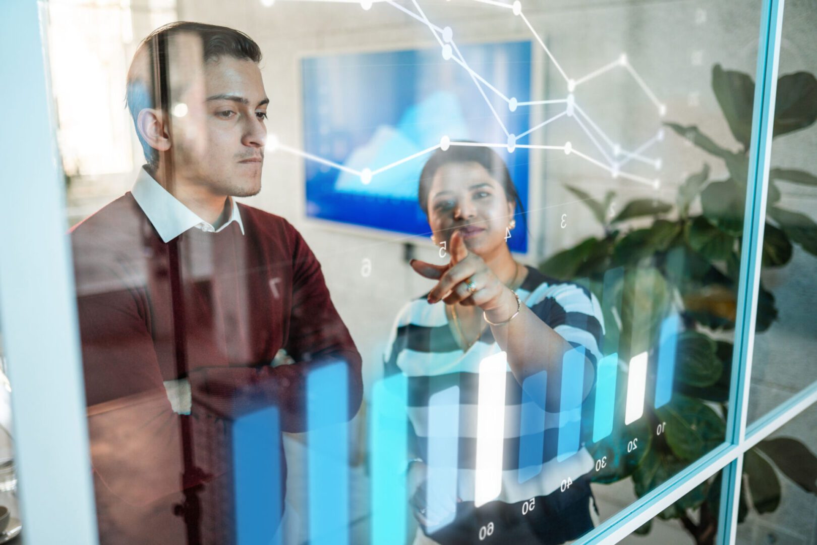 Team reviewing interactive bar chart display