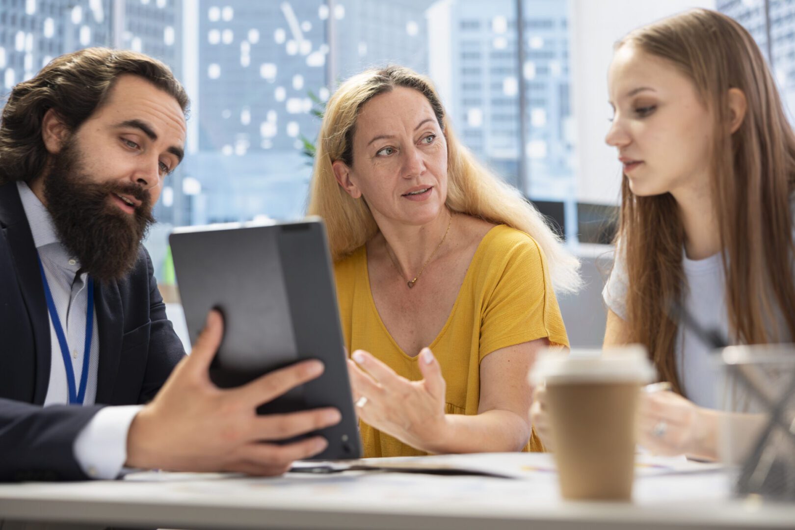 Financial adviser assisting clients in setting up investment accounts using device, conducting audit. Consultant utilizing financial planning software on tablet to help family