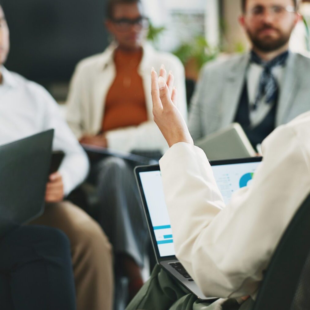 Laptop, discussion and businesswoman in meeting with team for planning, financial analysis or performance data. Computer, group and manager brainstorming stats for risk management with hand in office
